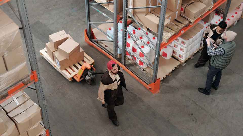 People transport goods through a warehouse